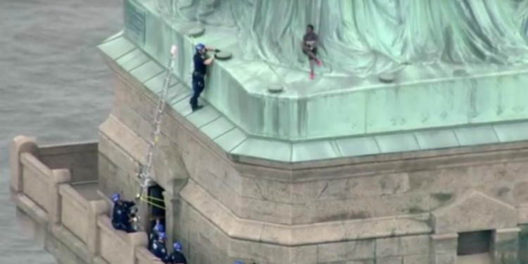 Protesta por política migratoria: mujer intenta escalar la Estatua de la Libertad