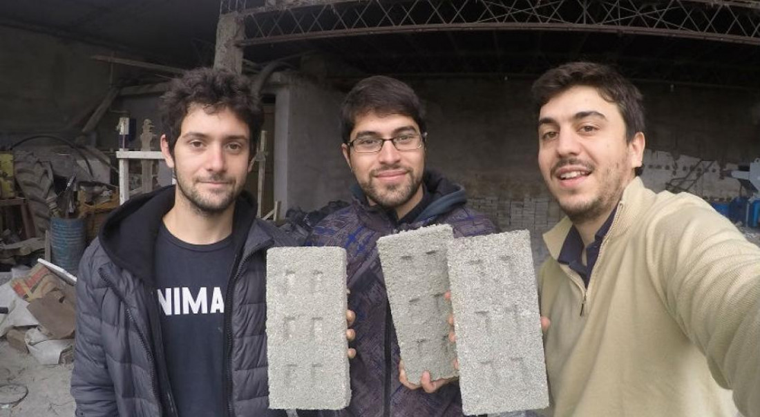 Tres jóvenes fabrican ladrillos con botellas plásticas para usar en la construcción